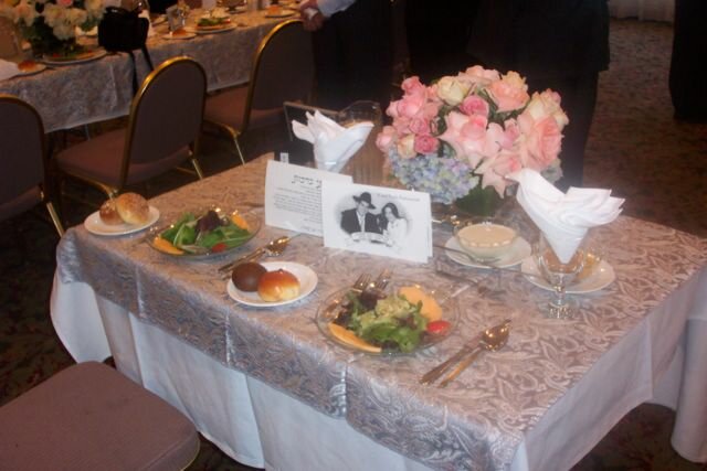 The bride and groom's place setting at the wedding feast table