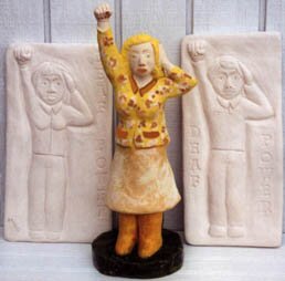 Figurines with one hand on ear and the other a raised fist (Sign for Deaf power)