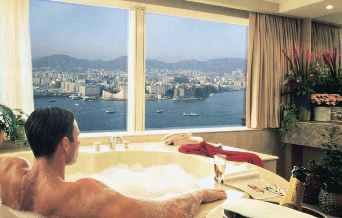 Man in bathtub with wine, enjoying the view