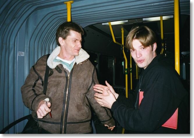 Two men speaking on the bus