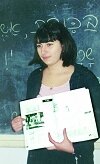 woman at blackboard with Hebrew lesson on it